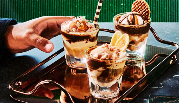 Three decorated affogatos on a tray.