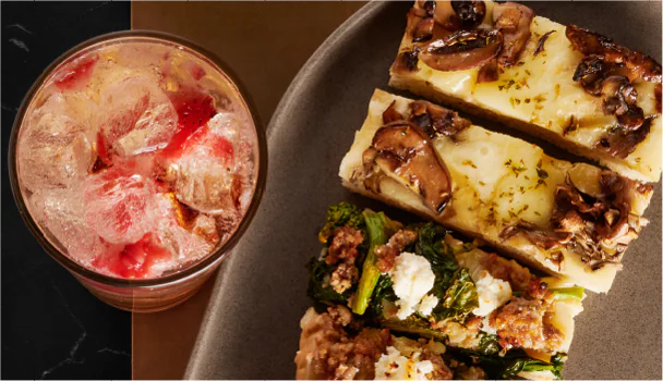 Pizza slice and an iced beverage.