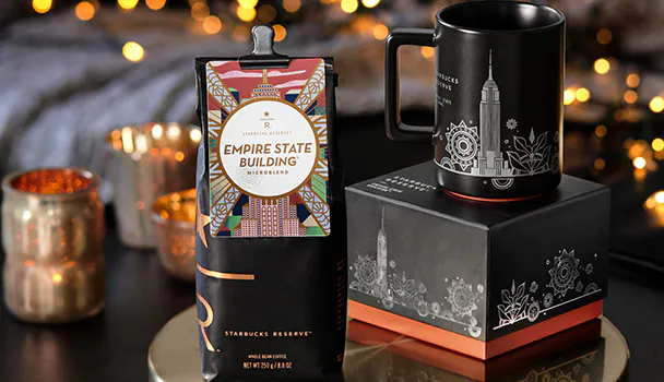 A bag of Starbucks Reserve Empire State Building coffee sits next to a mug with the New York City skyline.