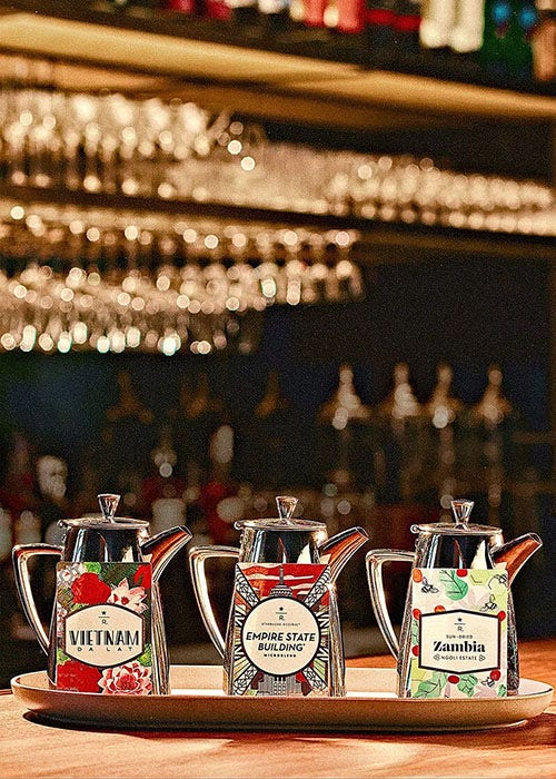 A trio of coffee pots and coffee cards.