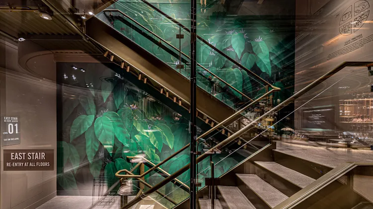 Part of a multi-floor wall mural in the Chicago Roastery stairwell, showing coffee plant greenery