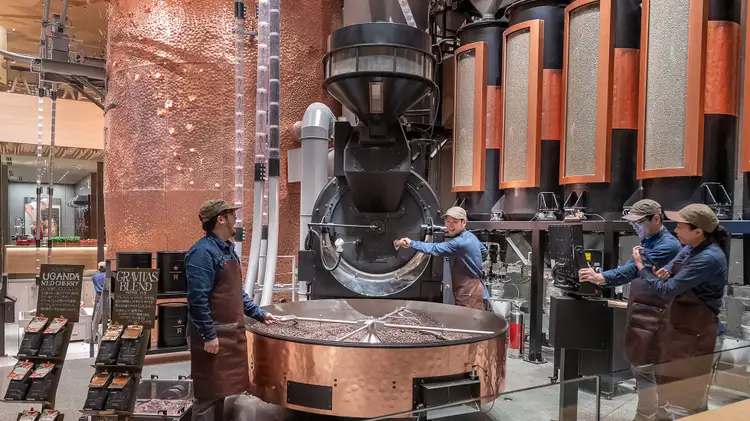 Master Roasters roasting coffee with the large roaster on the ground floor of the Tokyo Roastery