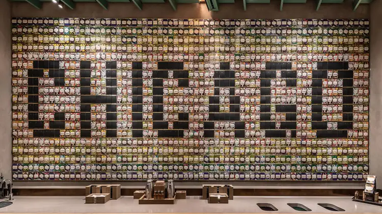 Rectangular display of hundreds of colorful Starbucks Reserve coffee cards on a large wall, with &quot;CHICAGO&quot; spelled out within
