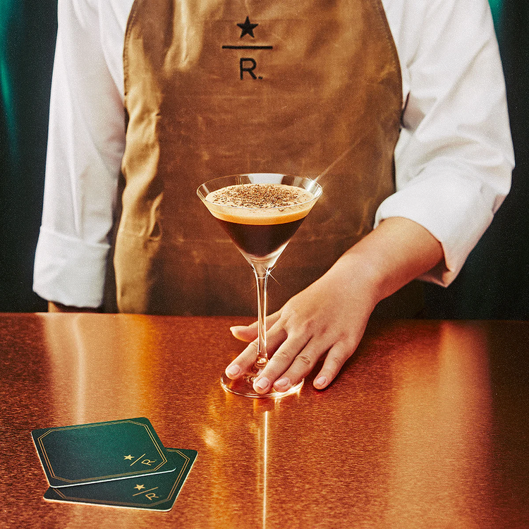 A bartender serves an espresso martini.