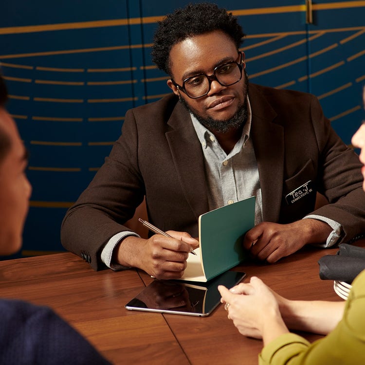 An event specialist listens to two clients discussion.
