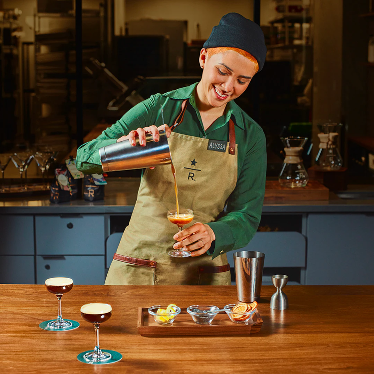 A bartender pouring a cocktail.