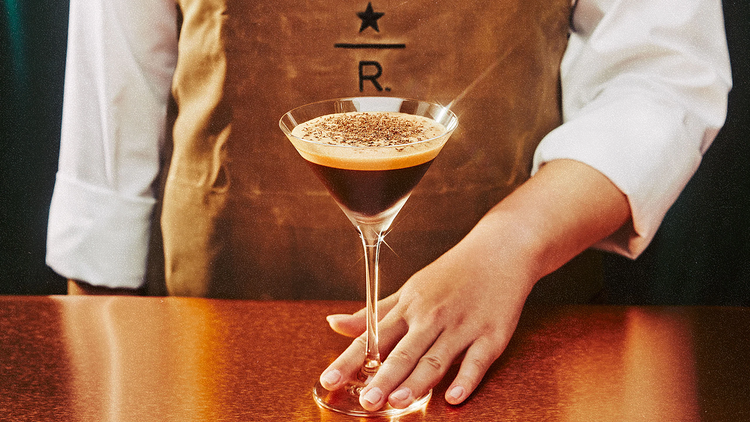 A bartender serves an espresso martini.