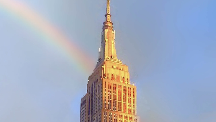 The Empire State Building with a rainbow.