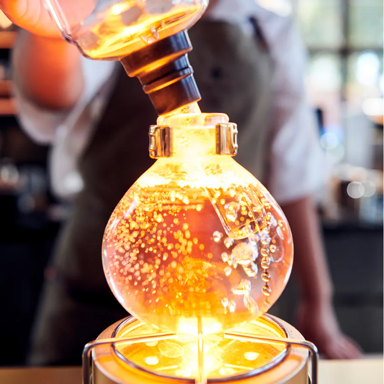 A siphon of coffee brewing.