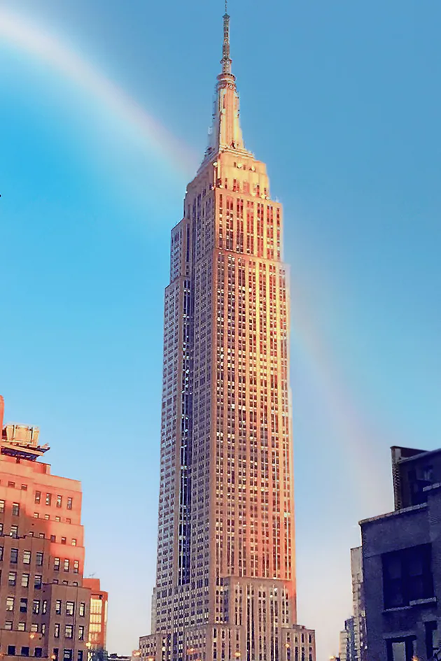 The Empire State Building with a rainbow.