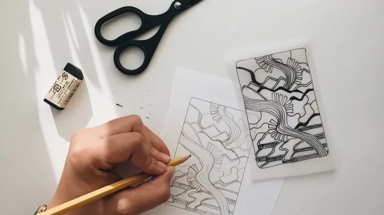 An illustrator drawing art for a coffee card.