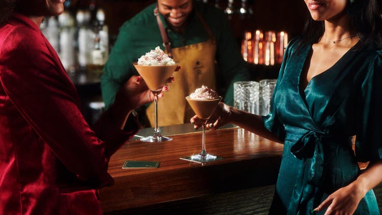 Two people drinking holiday martinis
